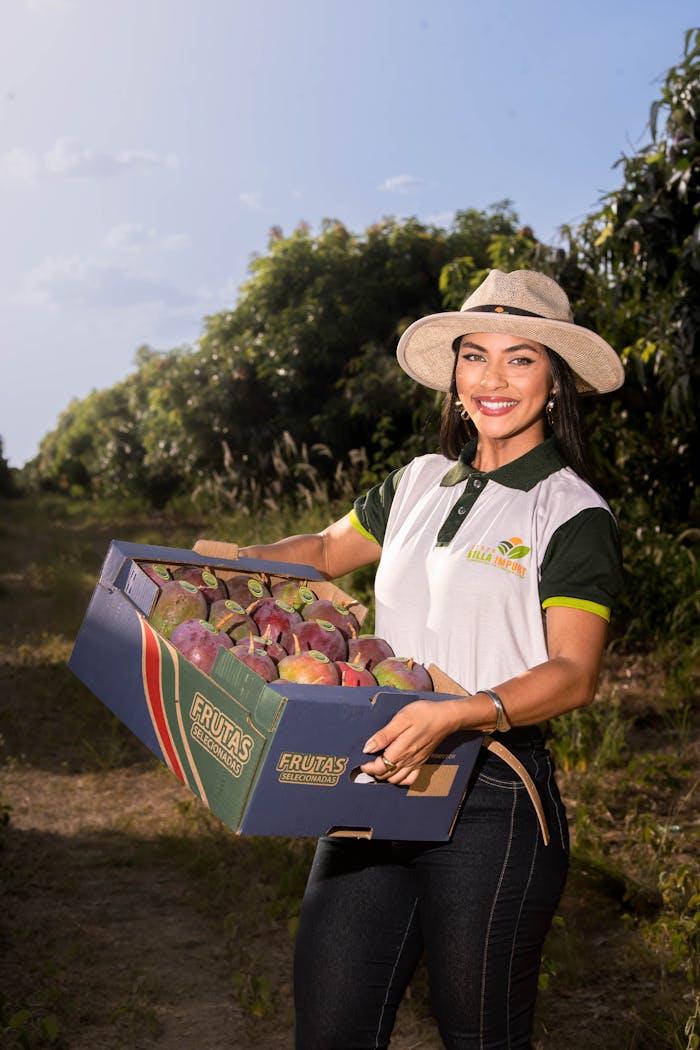 Smiling Woman Holding Freshly Harvested Mangoes